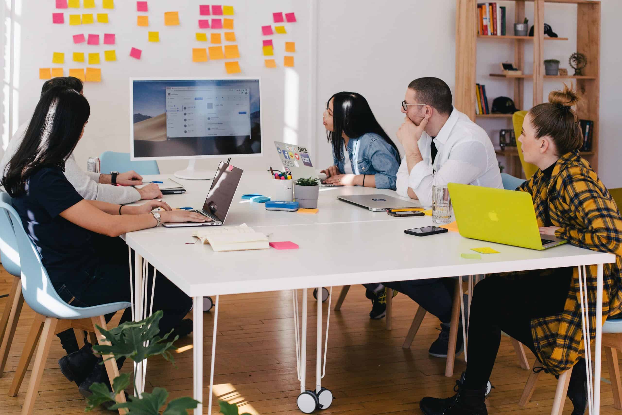 Group of people sitting at desk working together