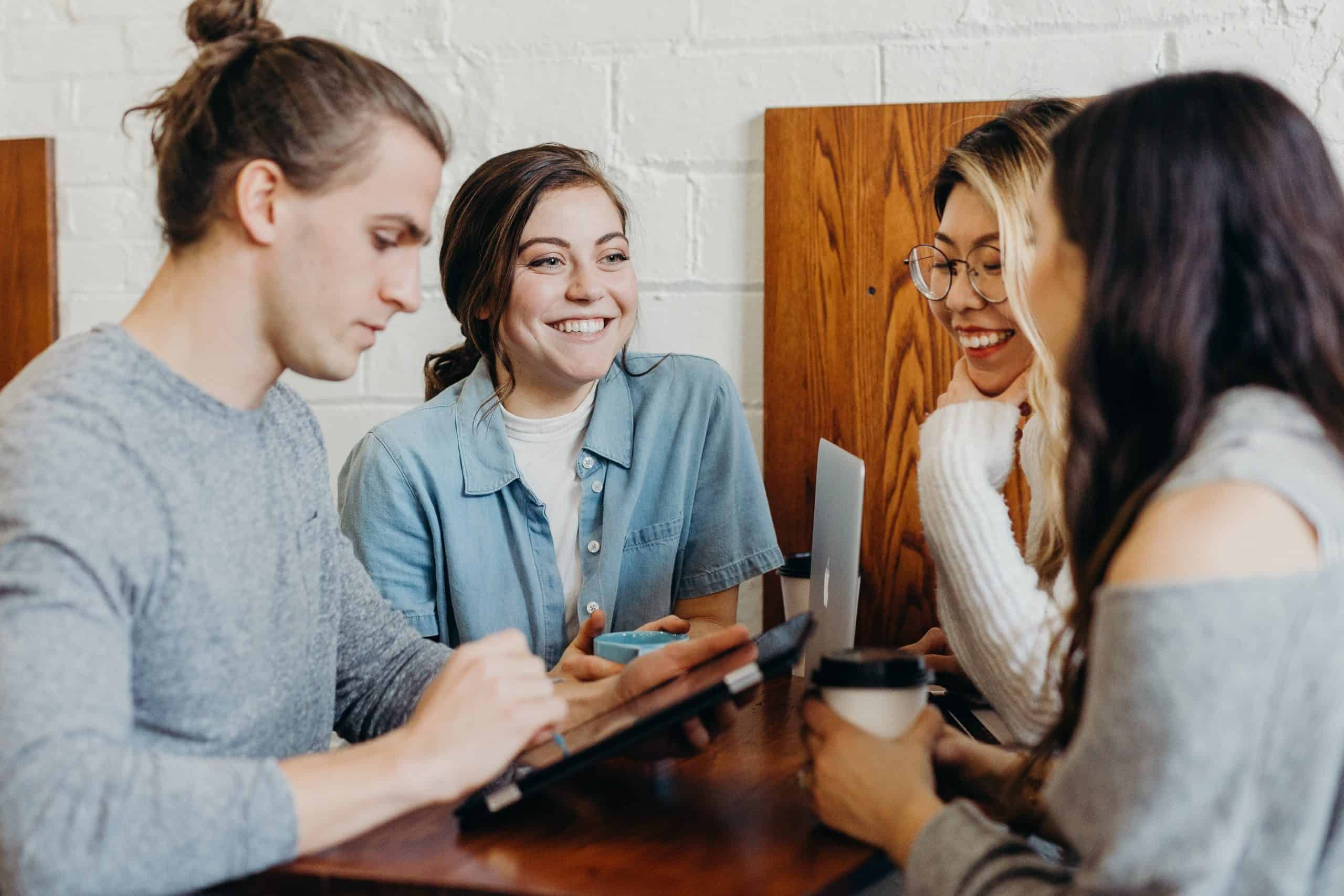 group of young adults with phones smiling-4