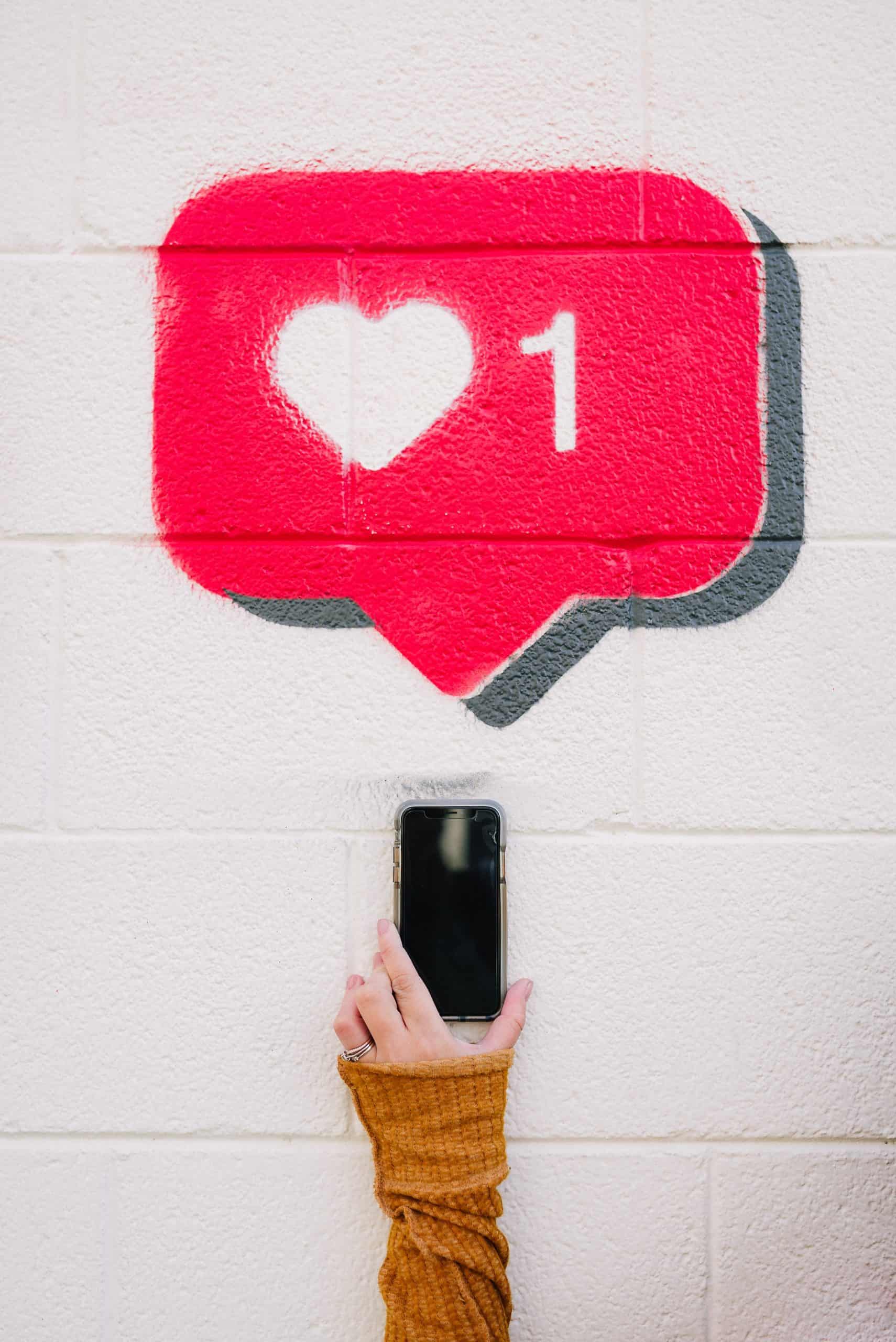 someone with phone and heart