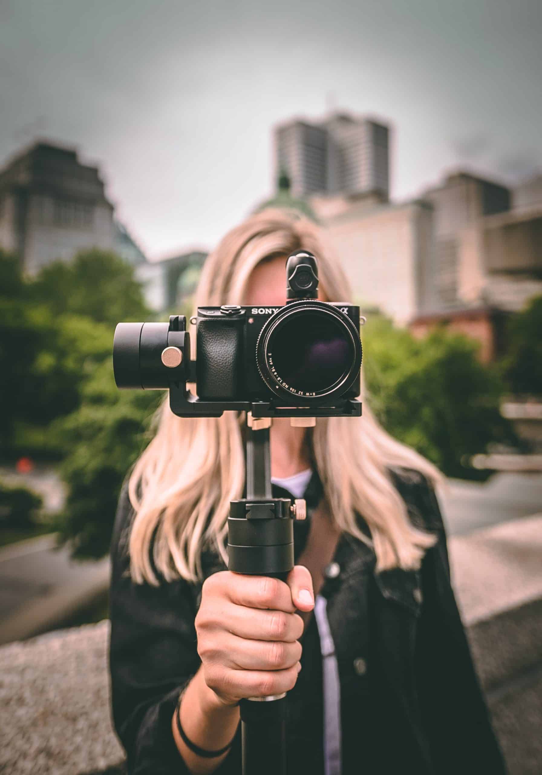 Woman holding a camera outside