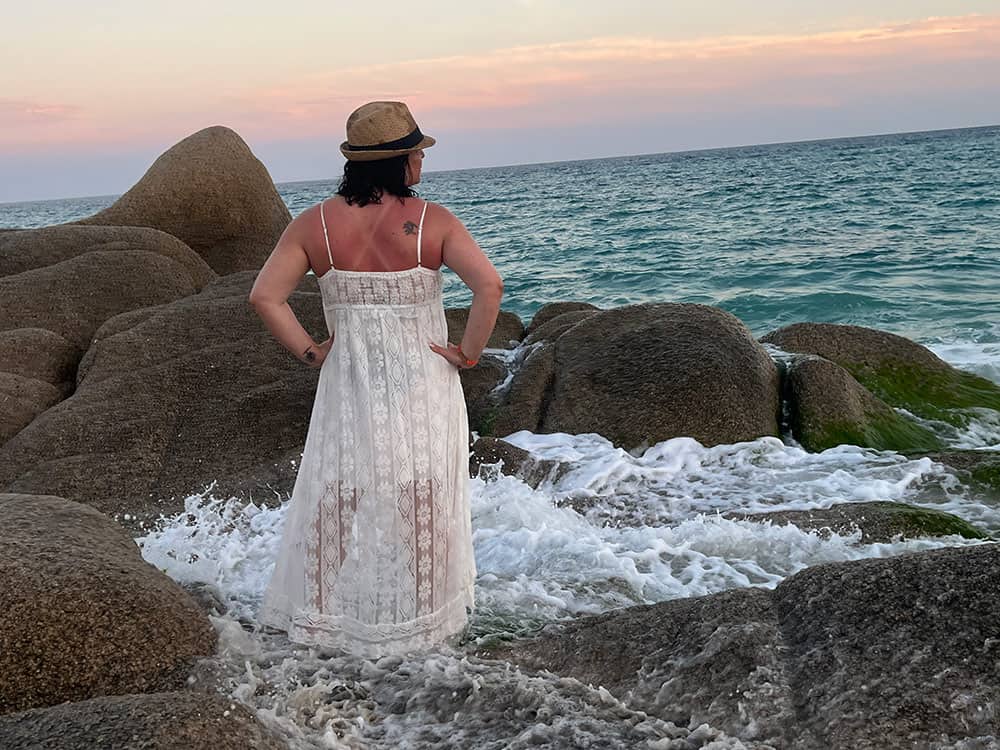 Jessika standing by the ocean reflecting on 16 years in business