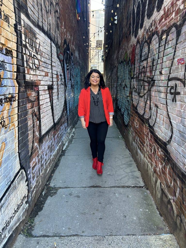Jessika in red jacket in alley