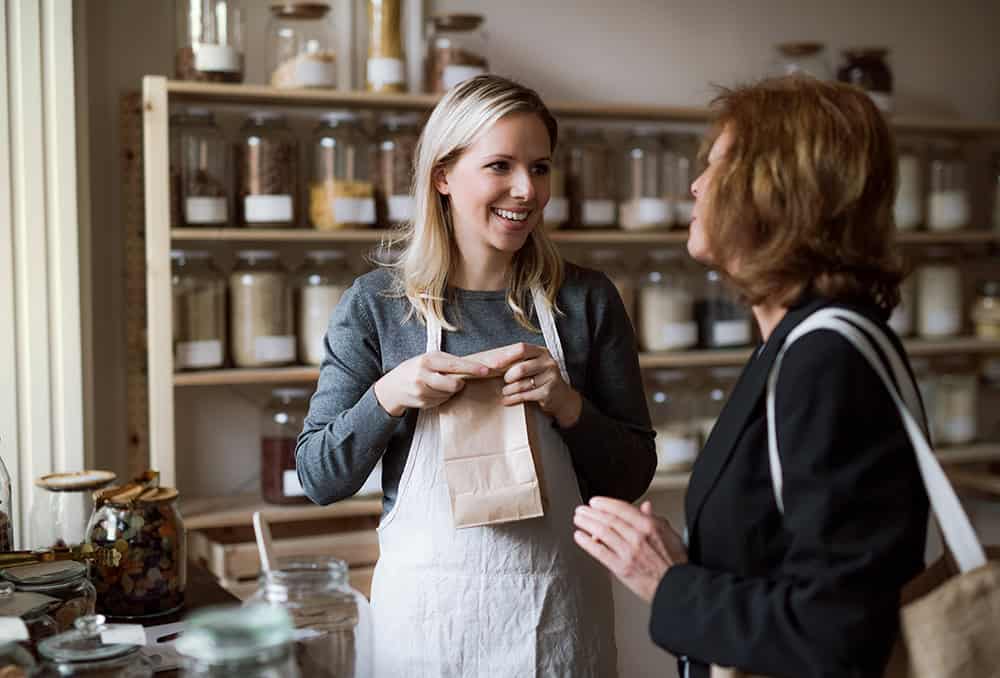Female shop owner with customer